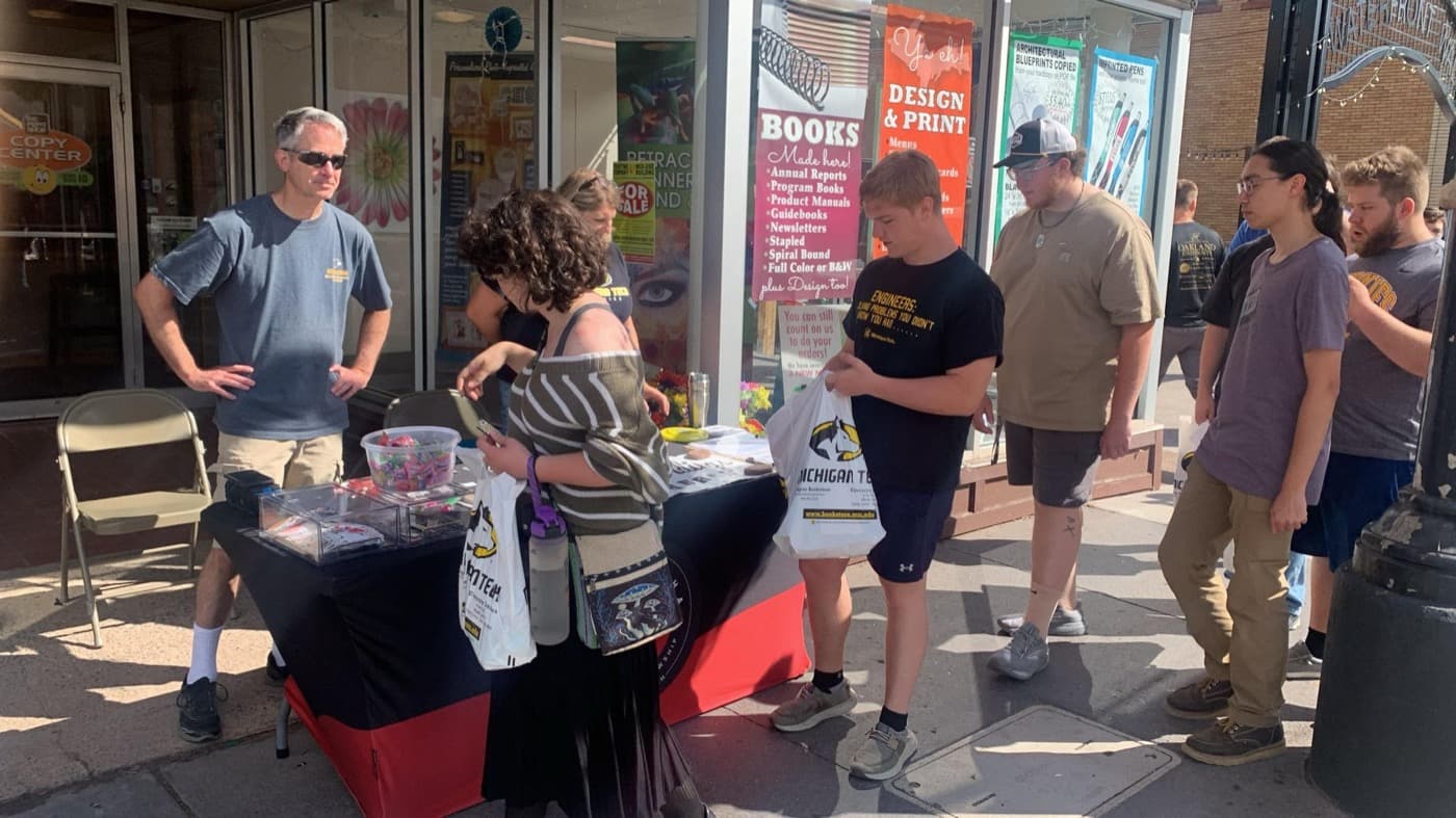 Students browsing an outreach table