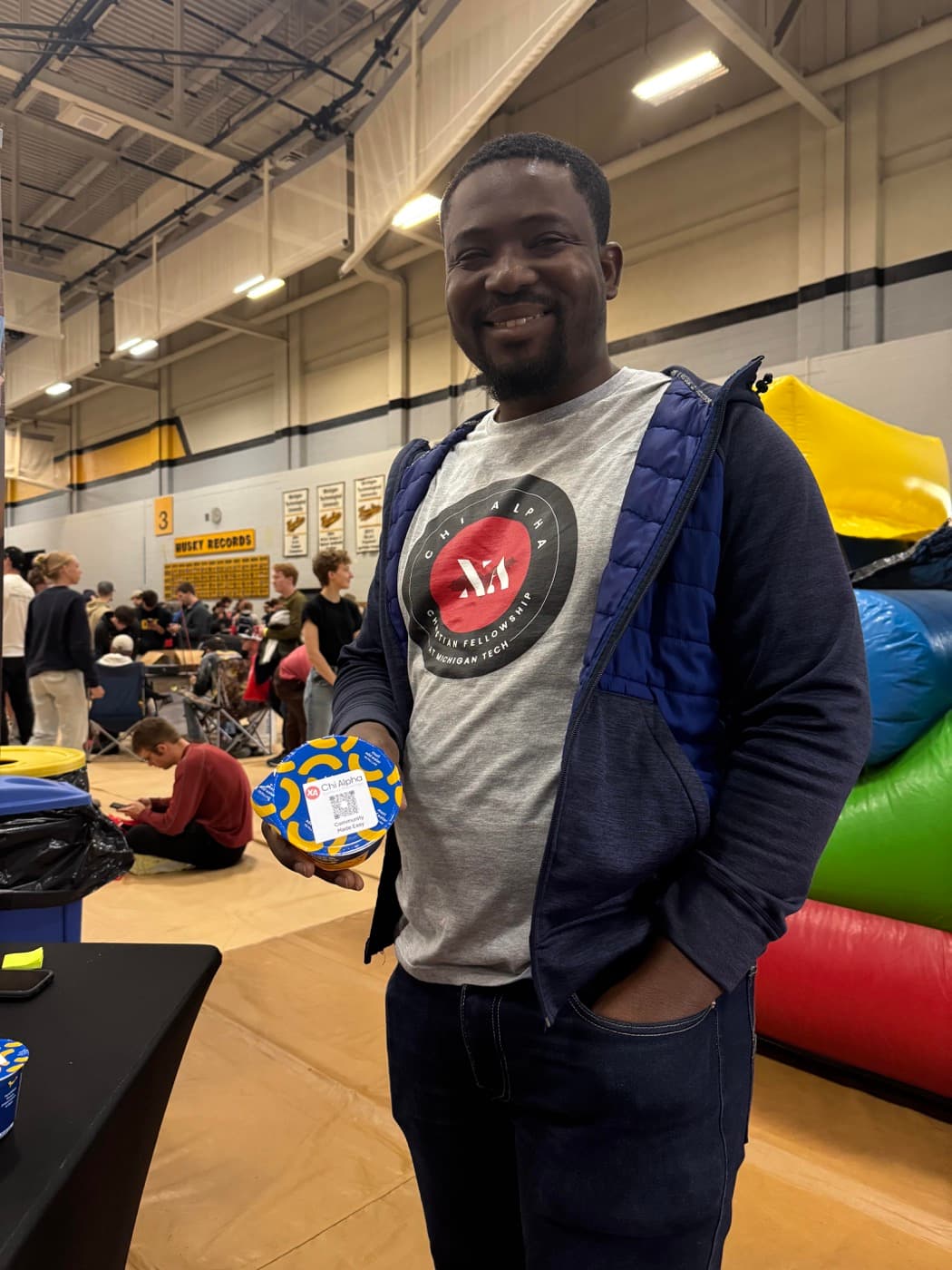 Student at the K-Day booth with stickers