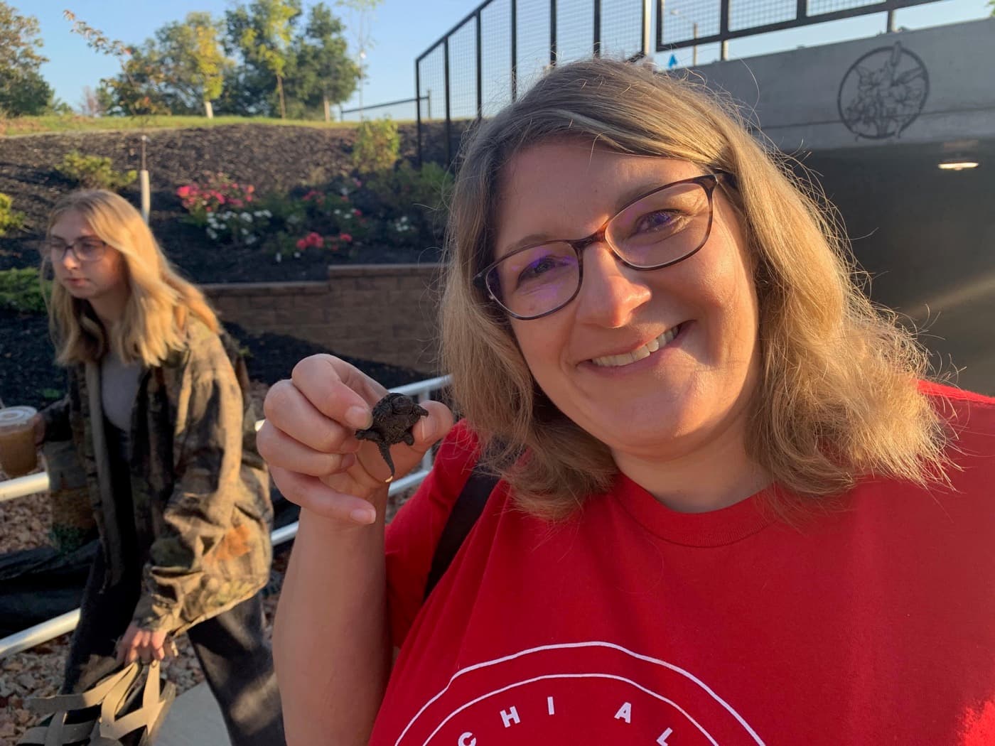Student holding a small turtle at retreat